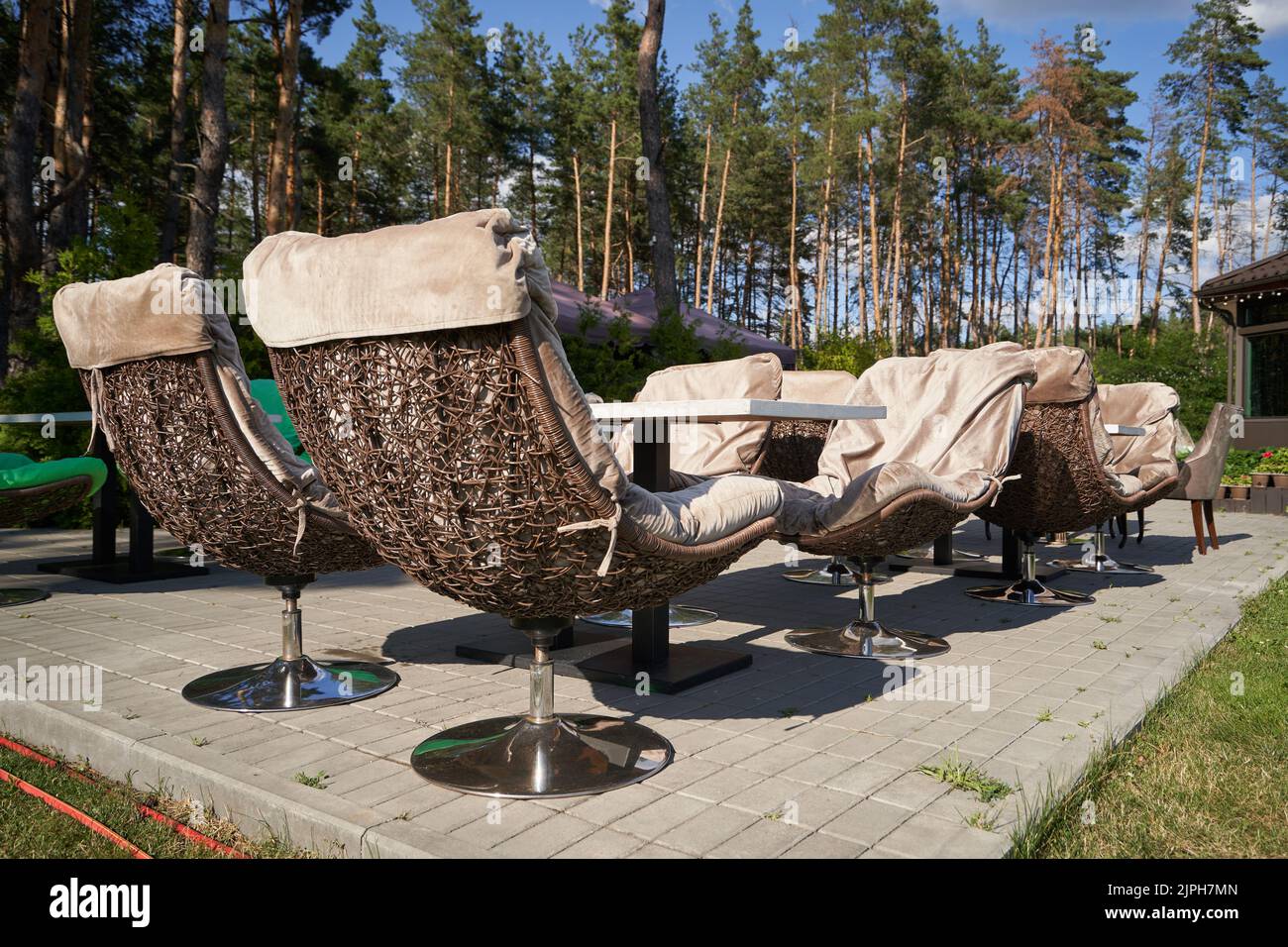 Comfortable wicker chairs in a restaurant by the forest Stock Photo Alamy