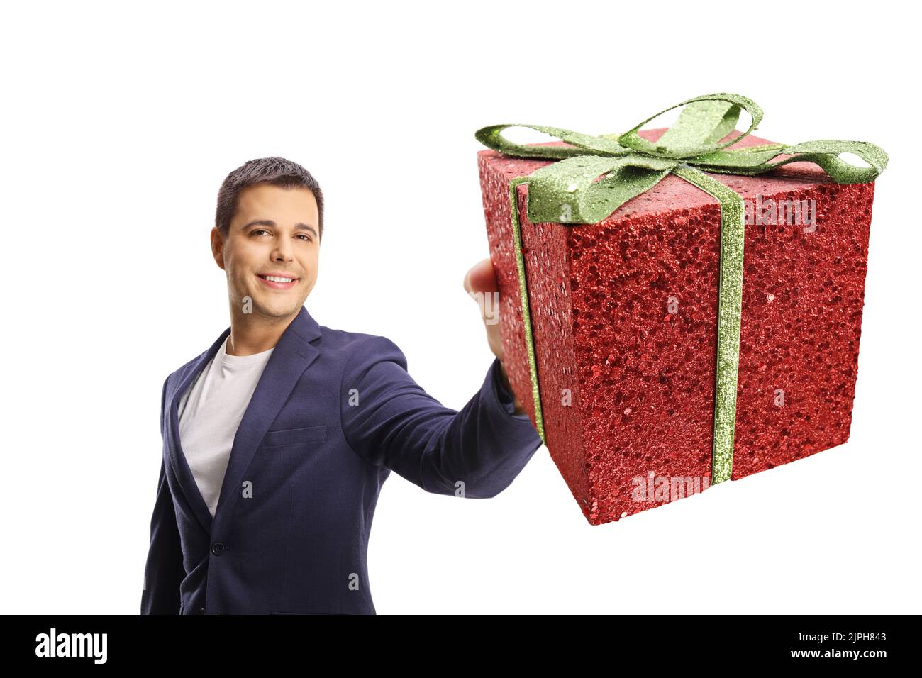 Happy young man showing a sparkly red gift box isolated on white background Stock Photo