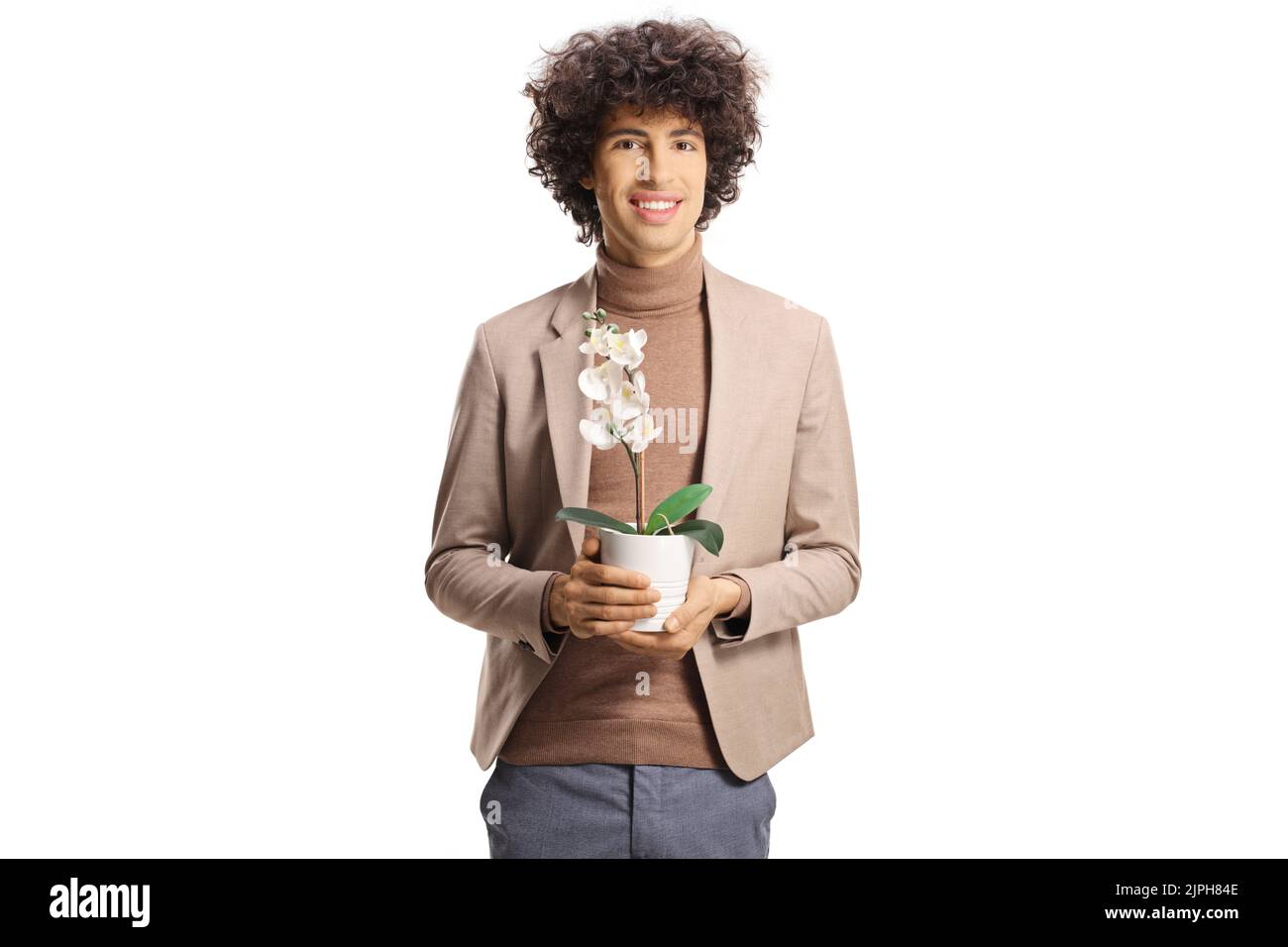 Young elegant man holding an orchid in a pot isolated on white background Stock Photo