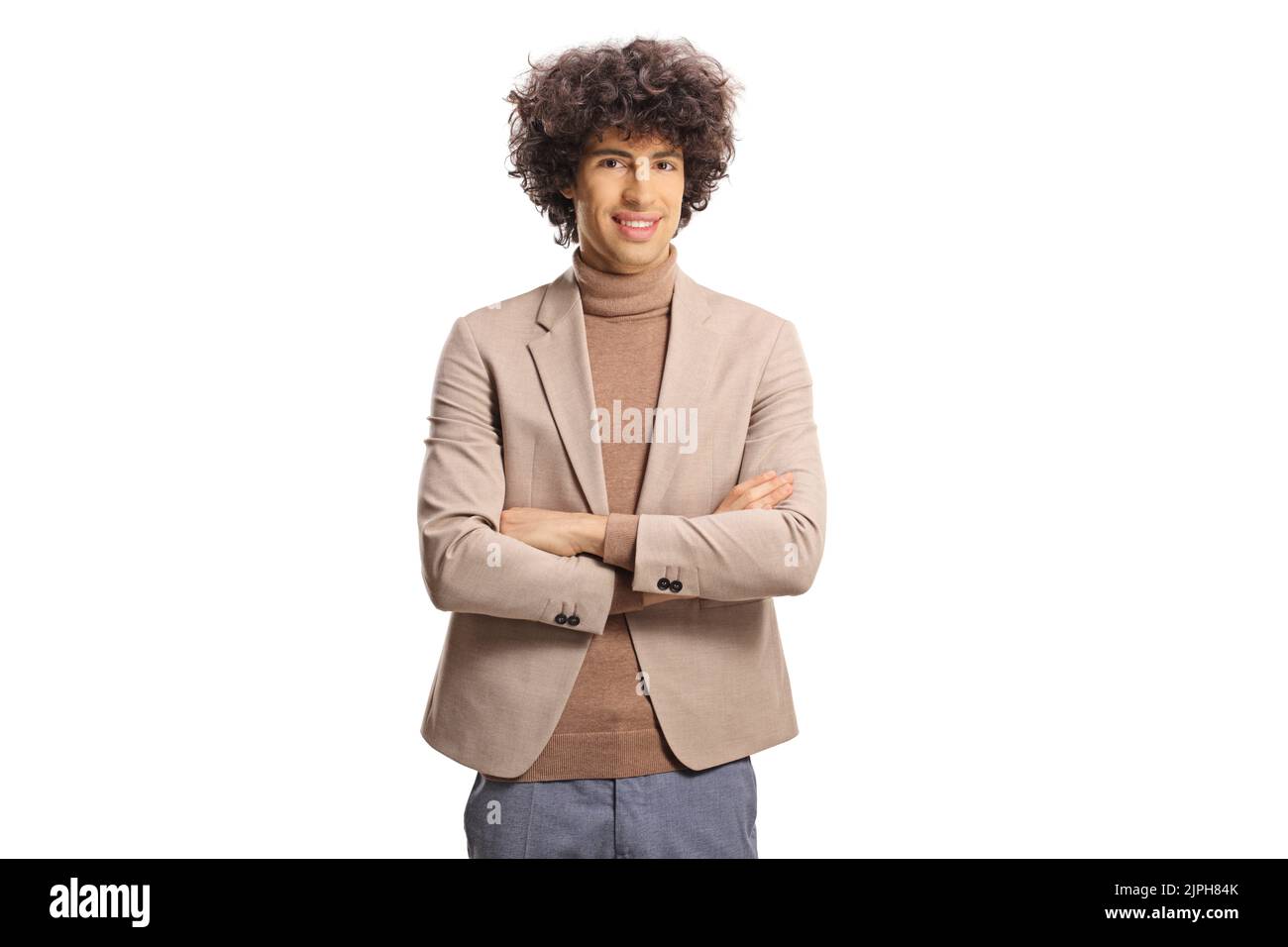 Young elegant man with a curly hair posing and smiling isolated on white background Stock Photo