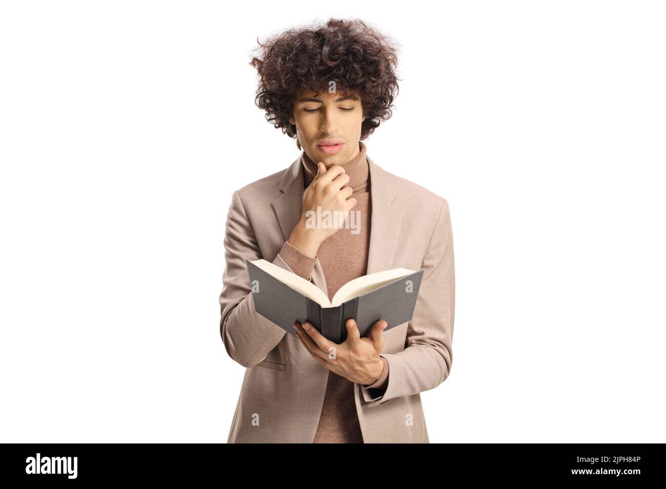 Young man with curly hair reading a book isolated on white background Stock Photo