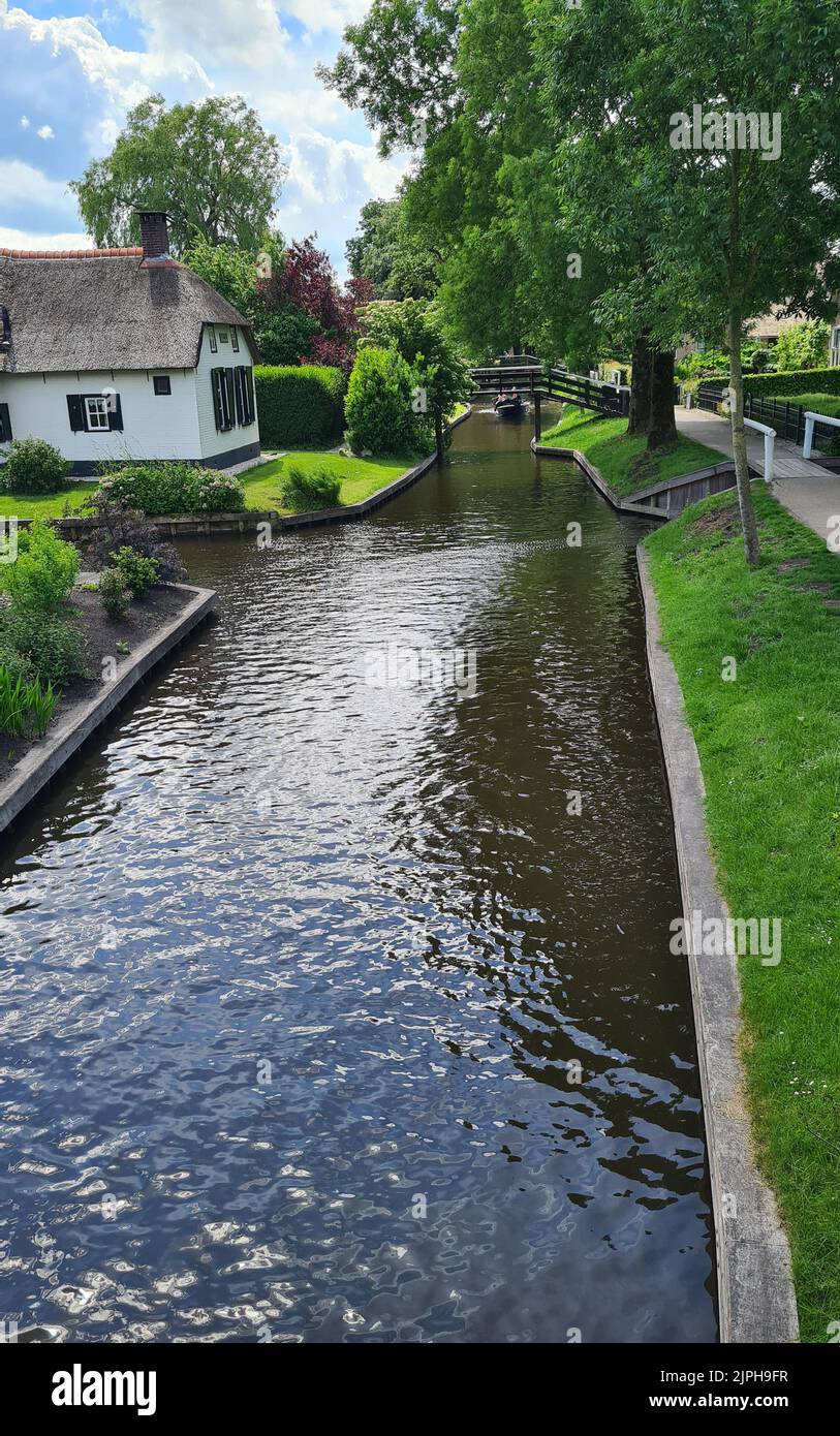 Tranquil view of the village of Giethoorn in the Netherlands, with beautiful country houses, water canals and colorful flowers Stock Photo