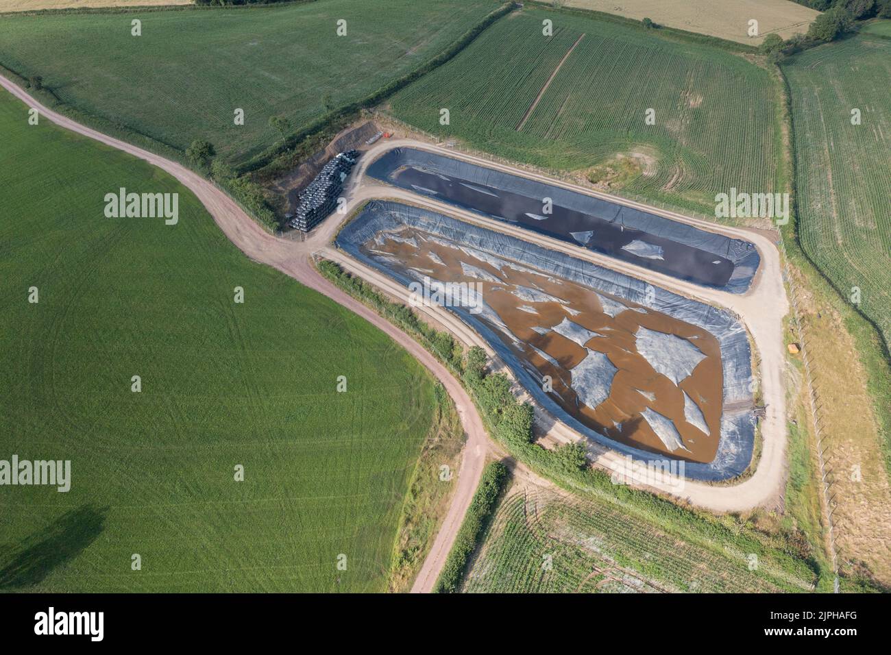 Aerial view of large slurry lagoons with membrane covers to prevent escape of ammonia, methane, carbon dixode, hydrogen sulfide and nitrous oxide Stock Photo