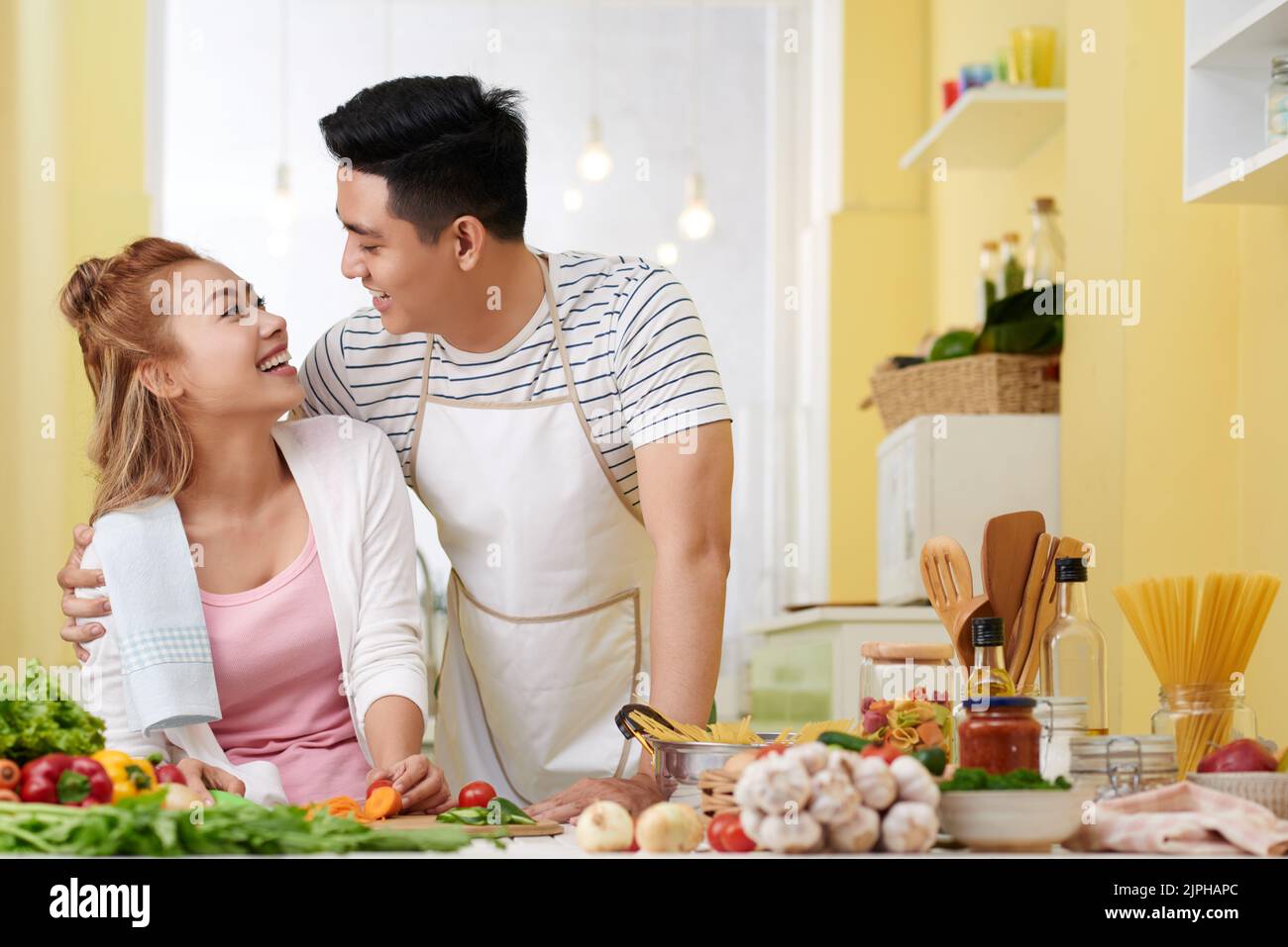 Happy young couple in love in their bright kitchen Stock Photo