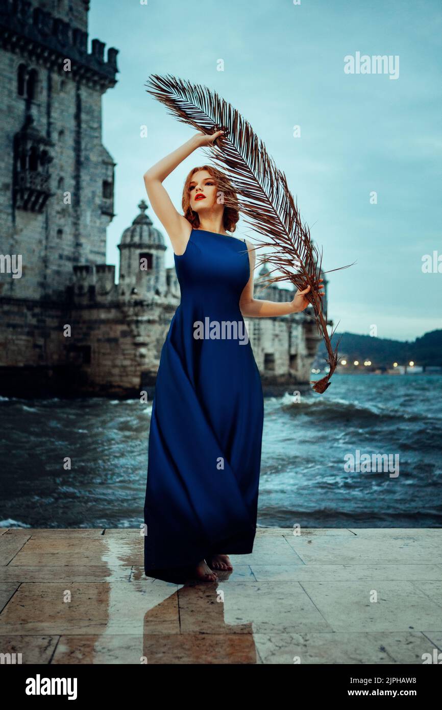 Beautiful woman in a blue dress and a sea Stock Photo - Alamy