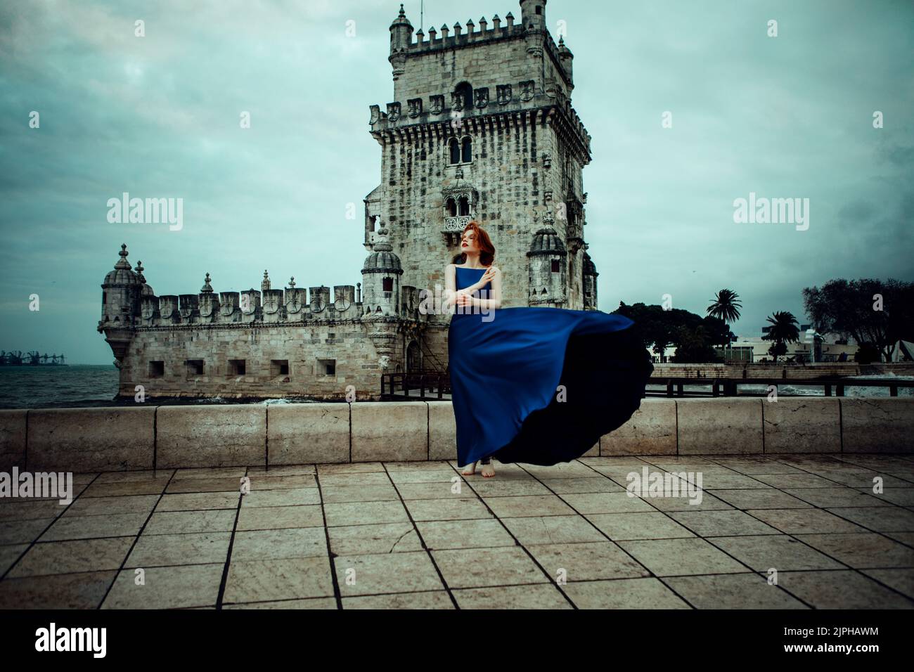 Beautiful woman in a blue dress and a sea Stock Photo - Alamy