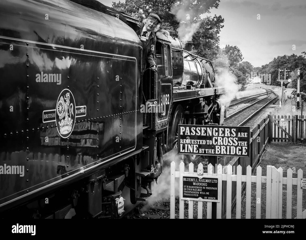 Black and white image of A steam train about to leave the station on the Bluebell Railway Stock Photo