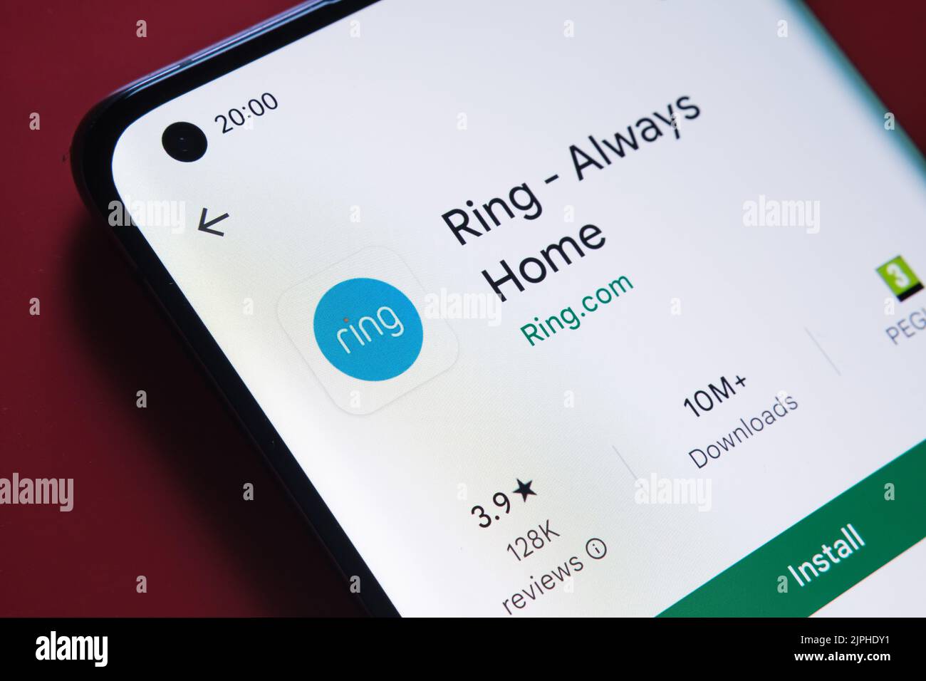ring app seen in Google Play Store on the smartphone screen placed on red background. Close up photo with selective focus. Stafford, United Kingdom, A Stock Photo