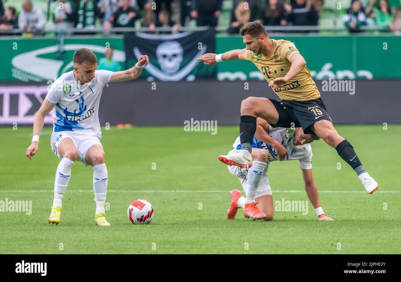 Kenneth Otigba of Ferencvarosi TC tackles Marko Futacs of MOL