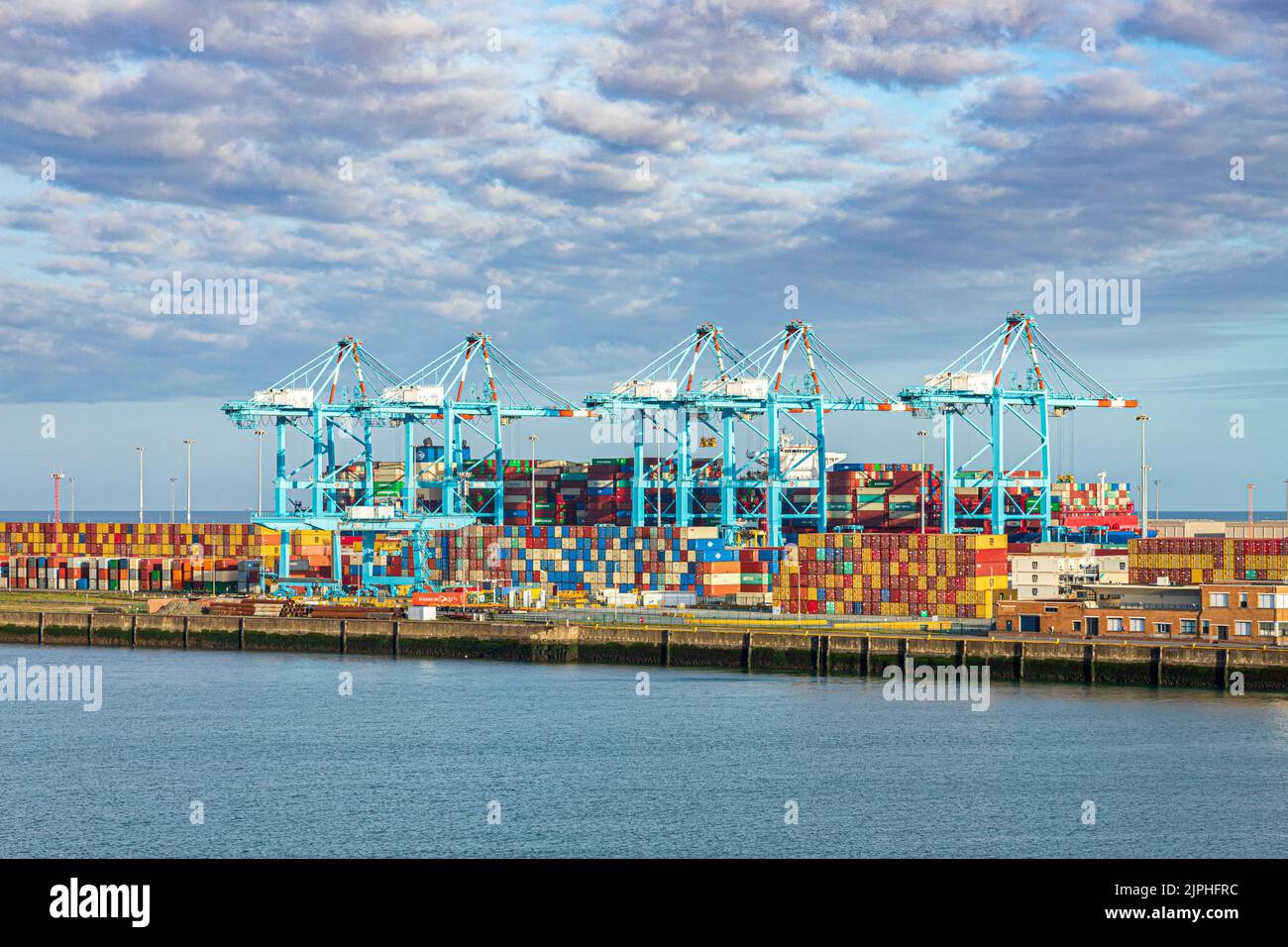 Containers awaiting transhipment on the dockside in the harbour at Zeebrugge, Belgium Stock Photo