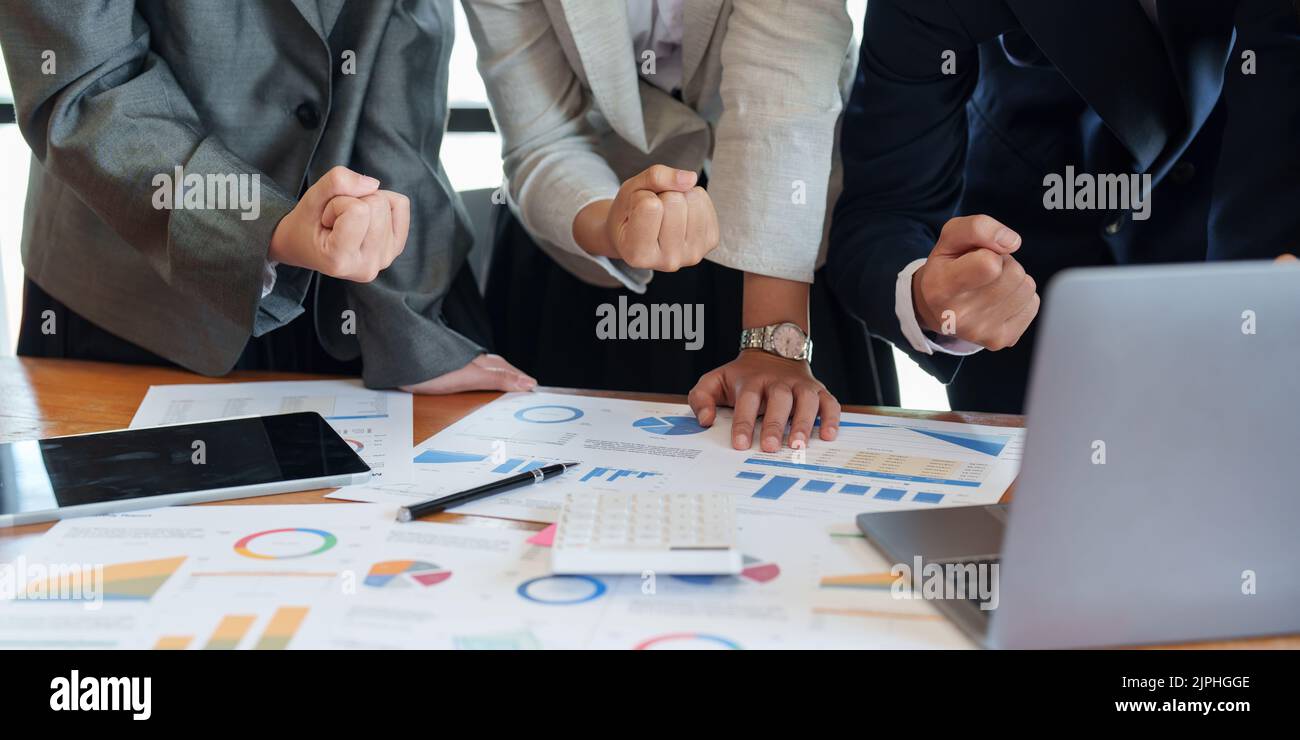 excited business team celebrate corporate victory together in office. Stock Photo