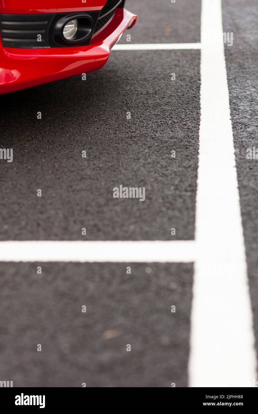 Red car parked in parking space Stock Photo Alamy