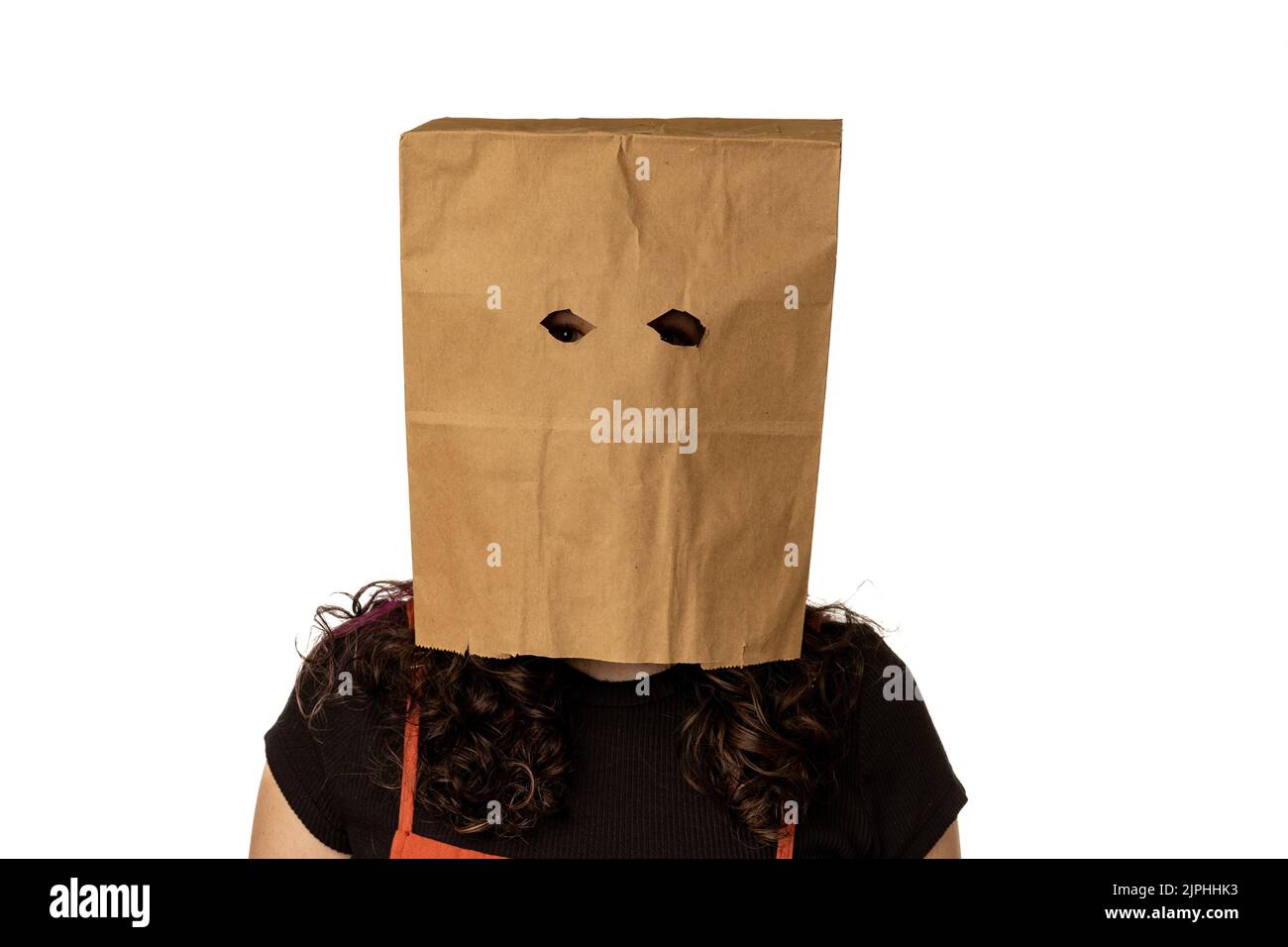 Woman wearing paper bag over her head on white background Stock Photo