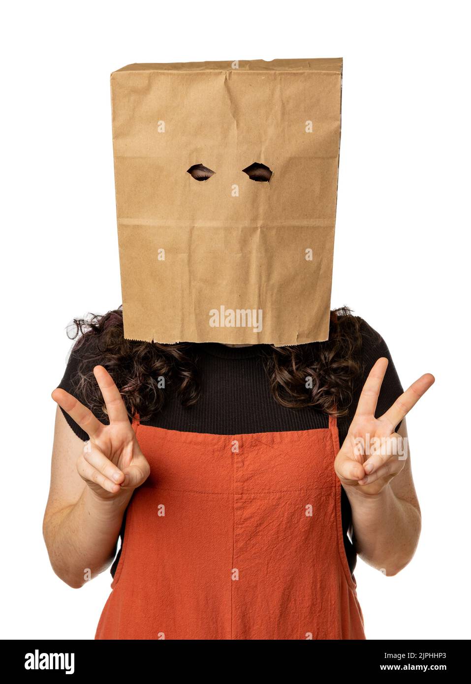 Young woman wearing paper bag over her head with two peace signs Stock