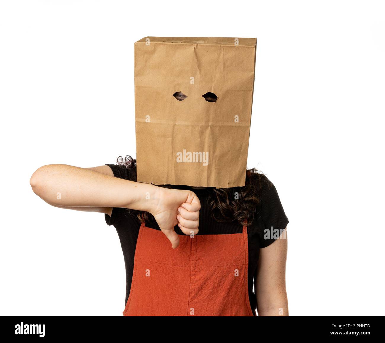 Woman wearing paper bag over her head and giving a thumbs down Stock Photo Alamy