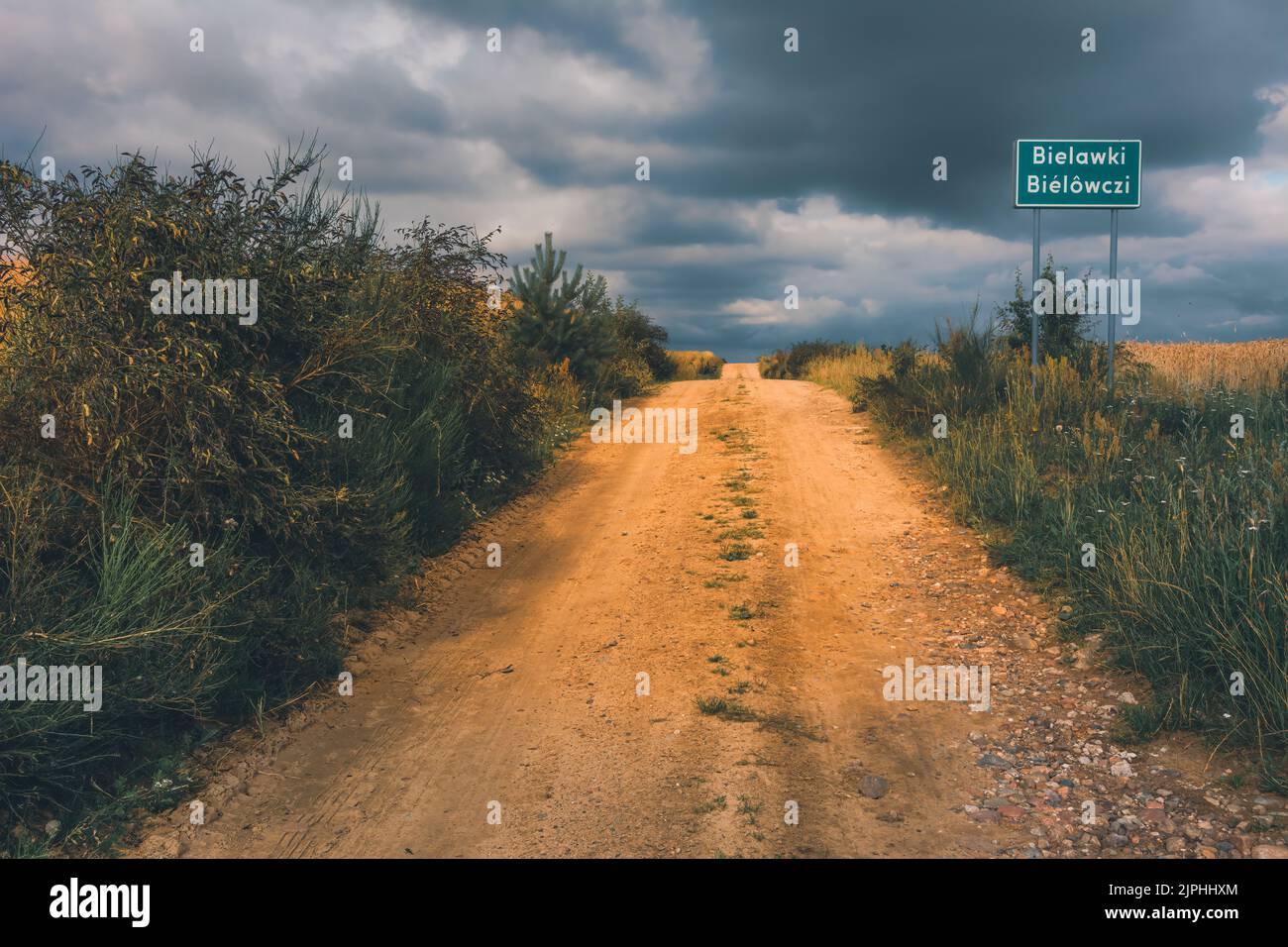 Dirt road under a stormy sky Stock Photo - Alamy