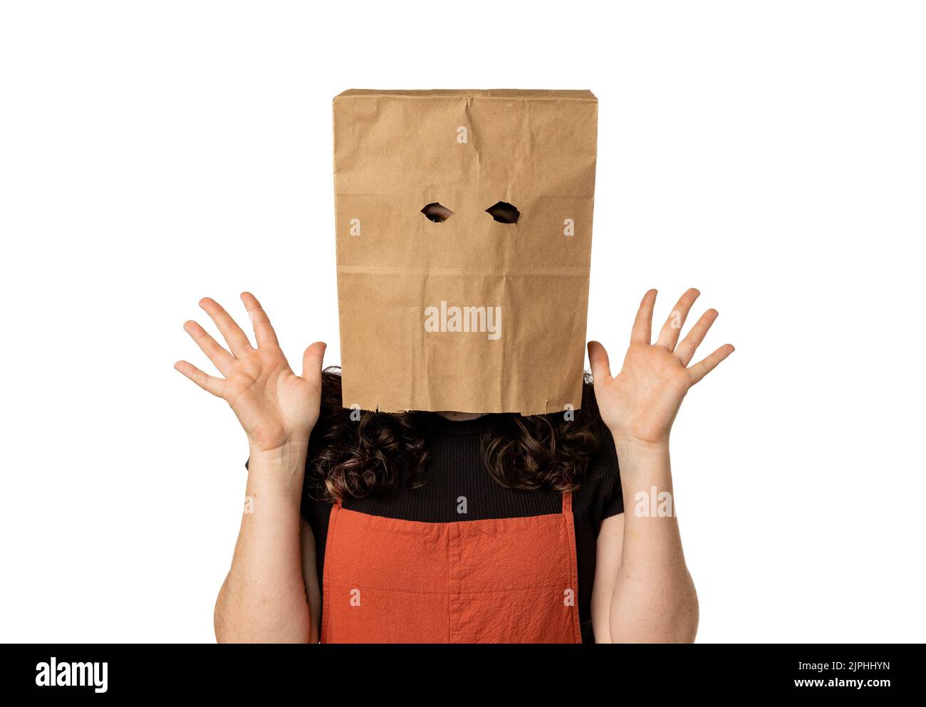 Woman wearing paper bag over her head looking surprised Stock Photo
