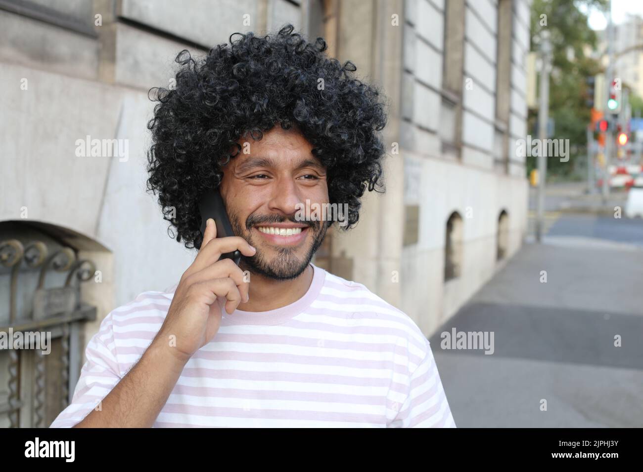 Multiracial man using mobile phone on the street Stock Photo