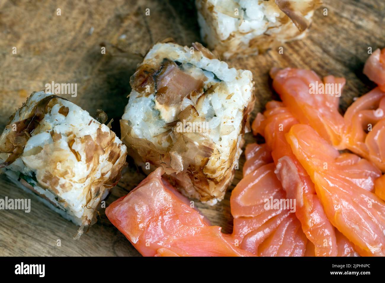 sushi with red salted fish and rice, Asian cuisine sushi of red raw fish with rice and other