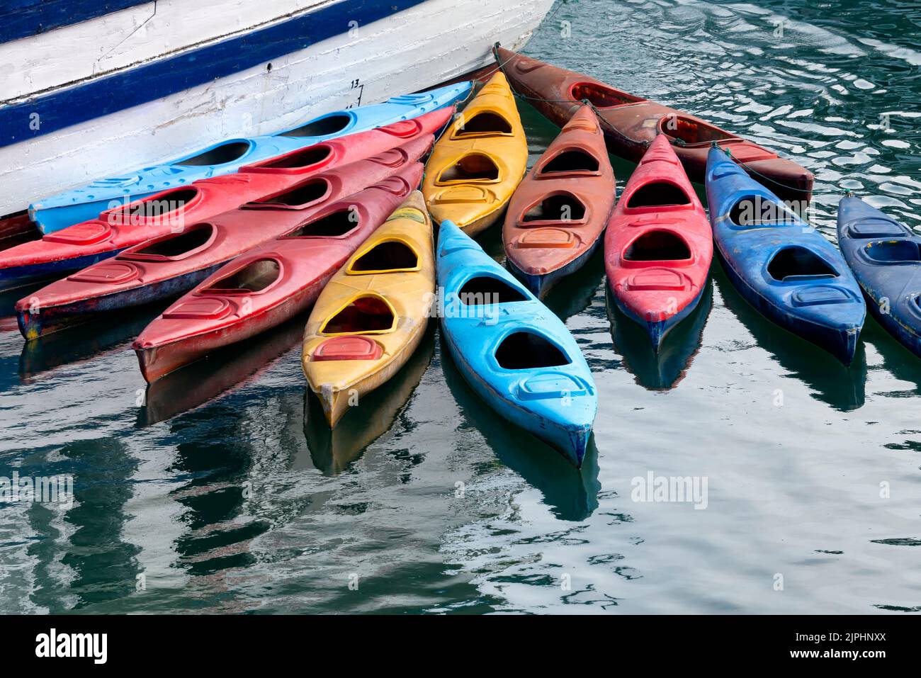 Colourful kayaks by boat Stock Photo