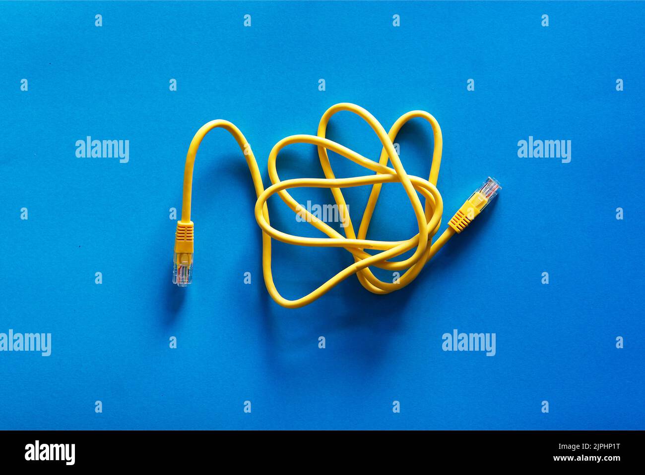 Yellow RJ45 or cable on blue background concept