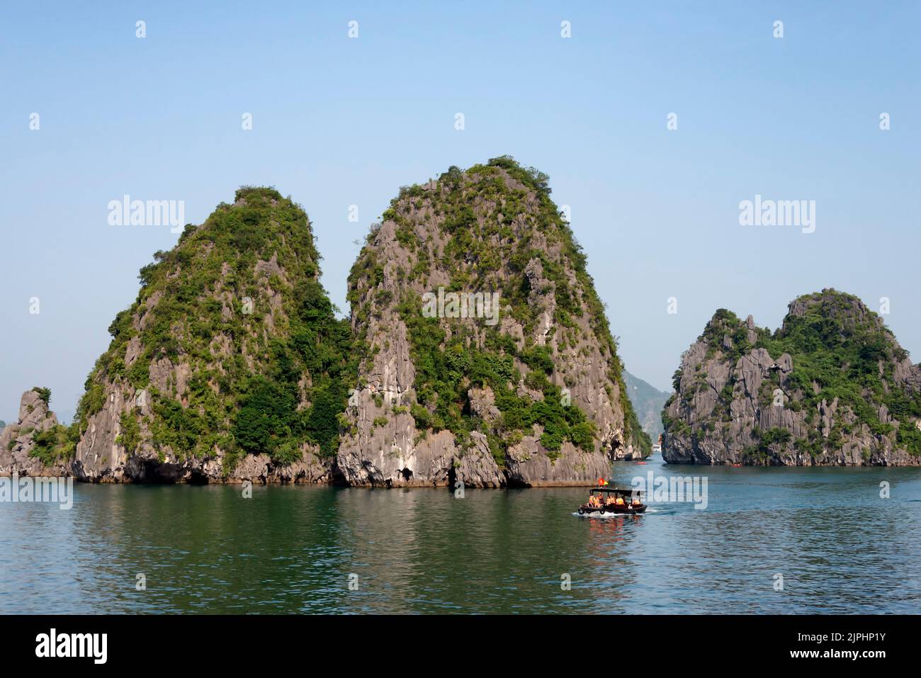 Boat with tourists in Ha Long Bay Stock Photo