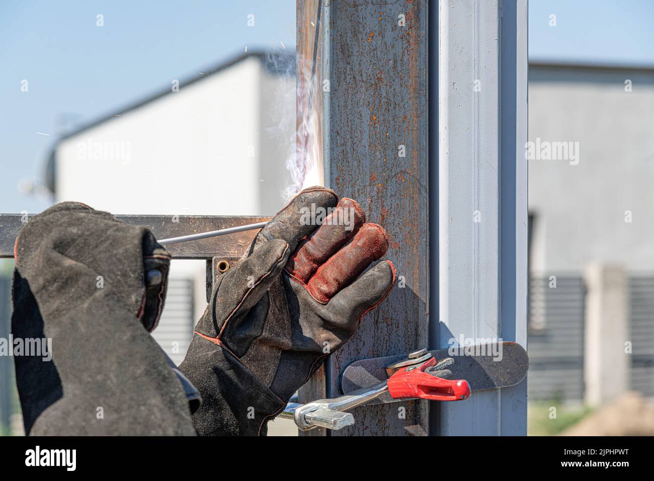A worker installs a metal profile. Stock Photo