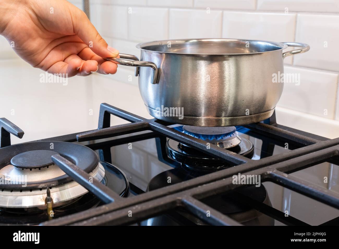 Pot is on the gas burner of the stove Stock Photo Alamy