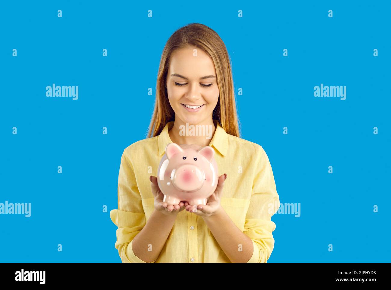 Smiling woman hold piggybank saving money for future Stock Photo