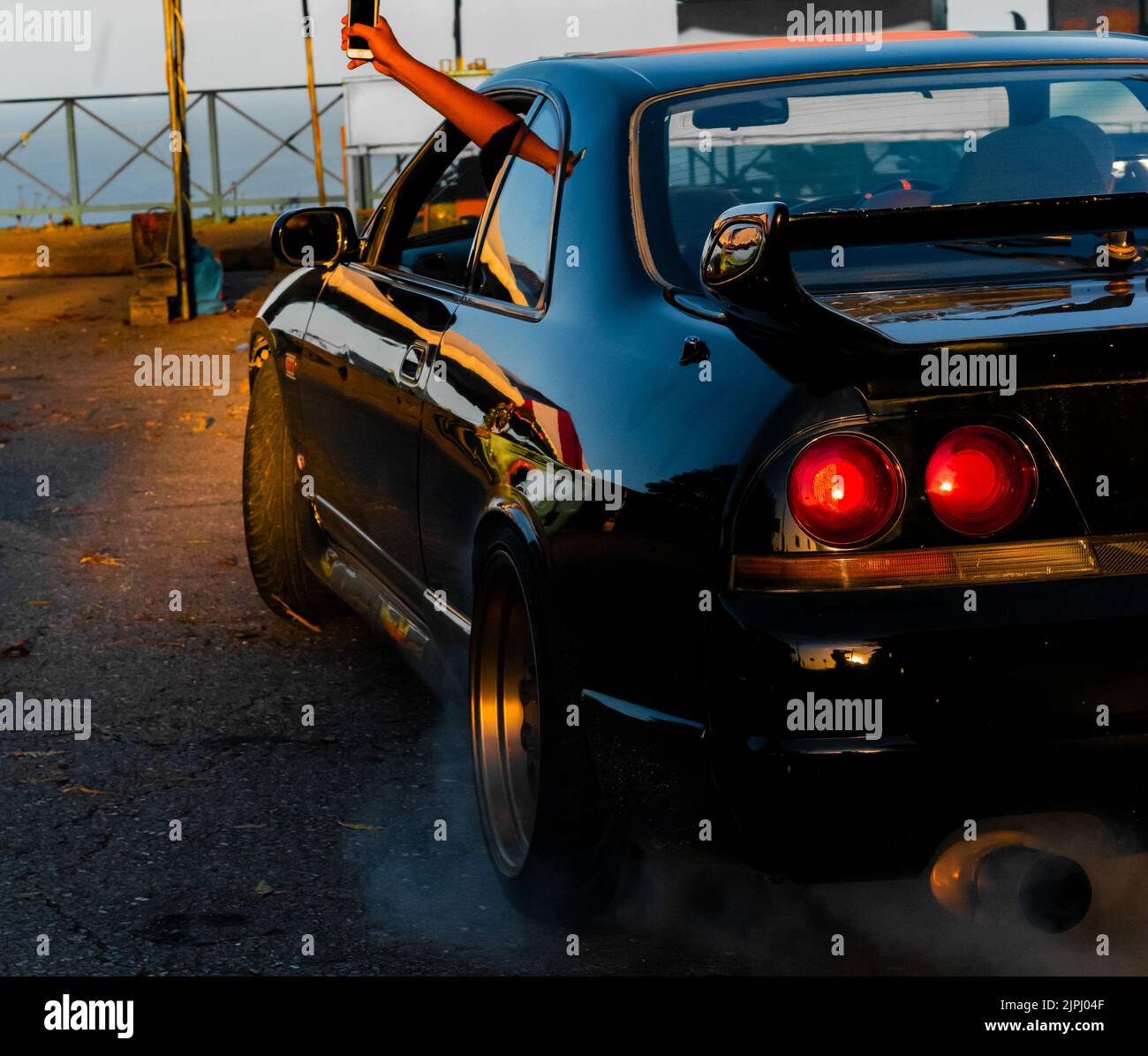 A beautiful shot of a black R32 doing a burnout in Trinidad and Tobago with Stock Photo