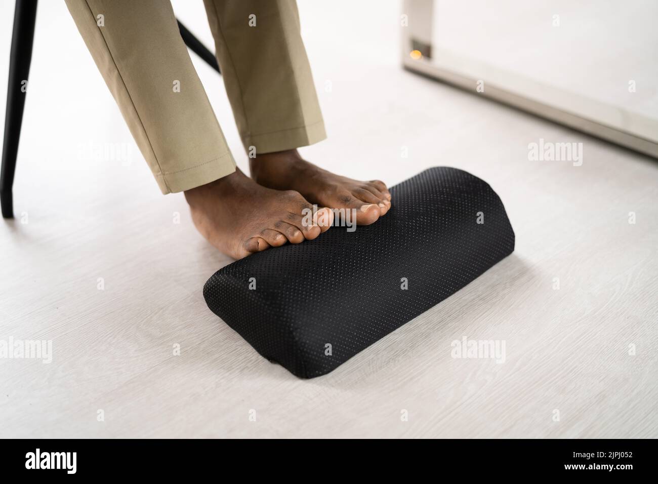 Footrest Against Pain In Office. Shifting Posture And Positions Stock Photo