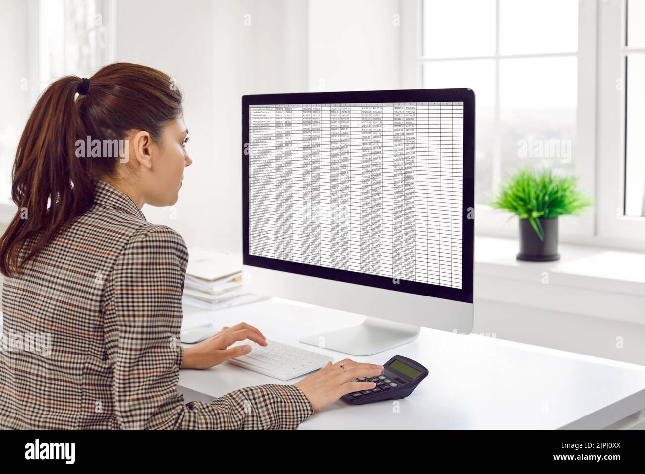Female accountant calculates company's financial accounts using ...