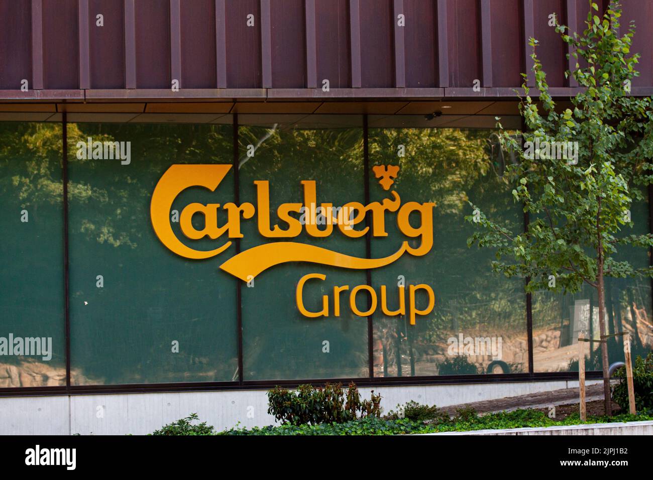 Logotype on head office of Carlsberg Group - one of the leading brewery groups in the world. Copenhagen, Denmark - August 18, 2022. Stock Photo