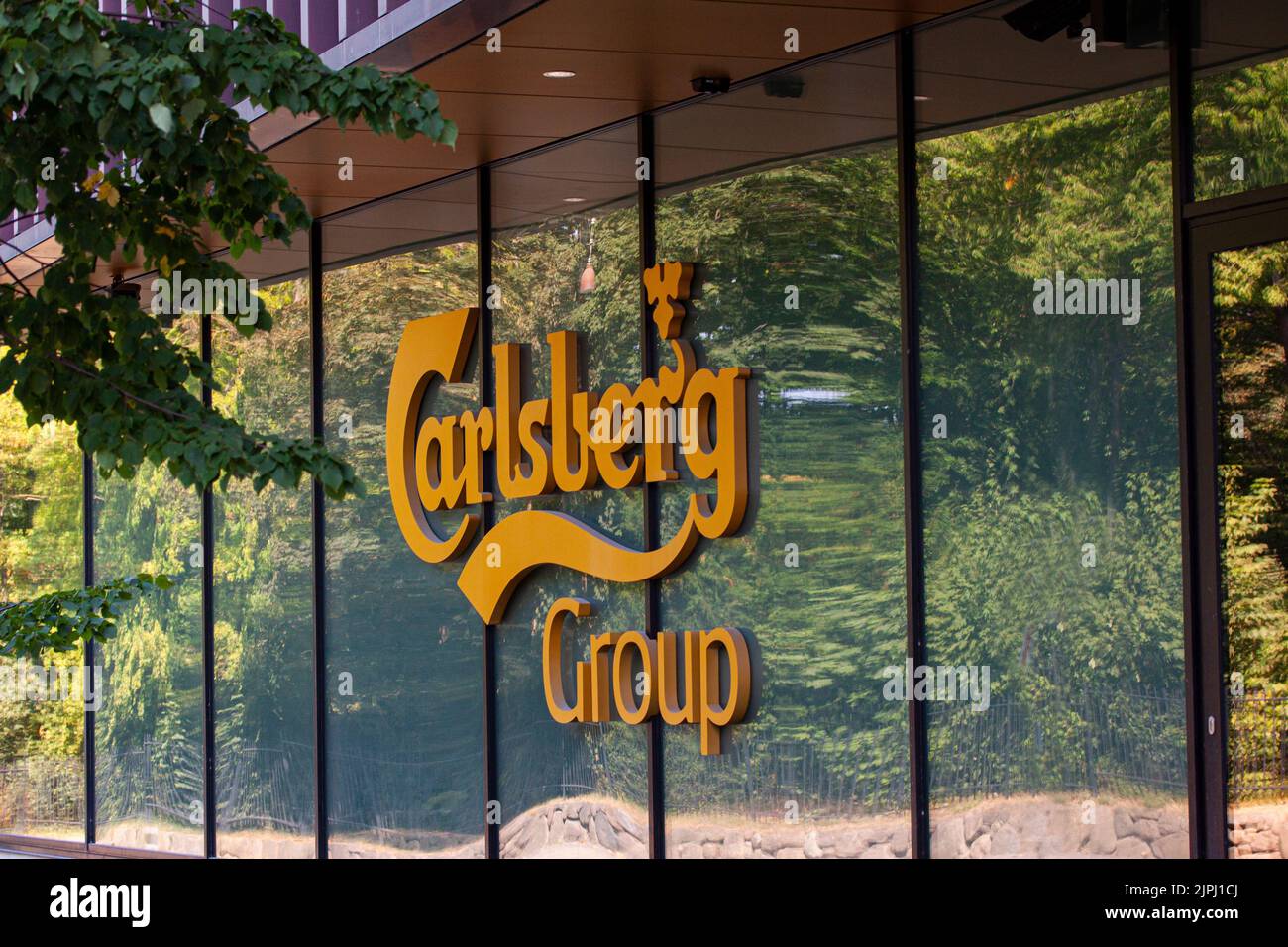 Logotype on head office of Carlsberg Group - one of the leading brewery groups in the world. Copenhagen, Denmark - August 18, 2022. Stock Photo