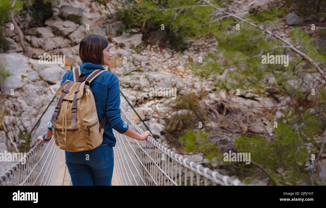 travel to Turkey, Kemer in autumn seasone. famous part of Lycian Way, Goynuk Canyon. Woman hiker trekking in mountains. Young lady walking with backpack in forest. Stock Photo