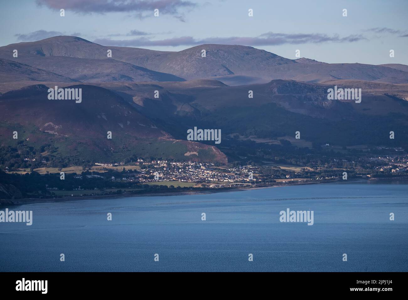 Dwygyfylchi and Penmaenmawr viewed from the Great Orme beyond the River Conwy estuary at first light at dawn on an early summer morning in North Wales Stock Photo