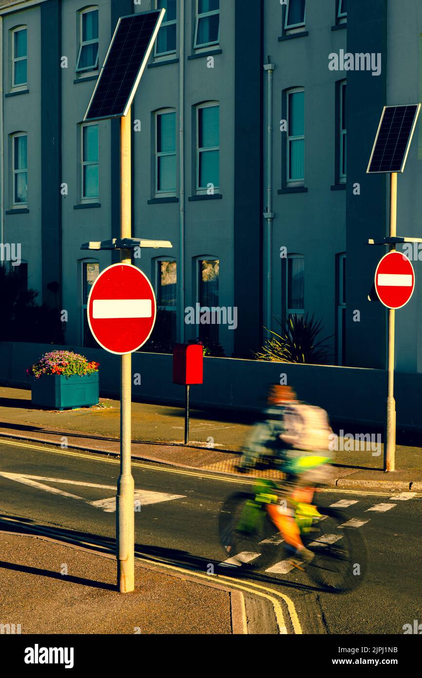 Blurred bicyclist passing by no entry sign Stock Photo