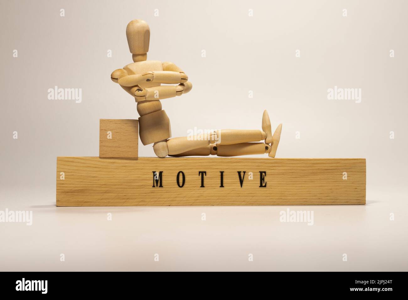 Motive written on wooden surface. Personal development and education. Stock Photo