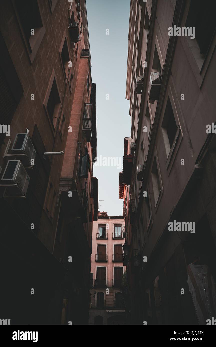 A vertical shot of an alley between residential buildings during ...