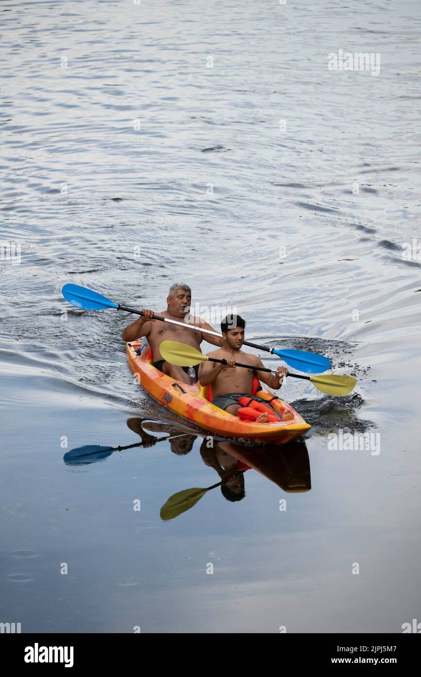 Austin Texas USA, August 14, 2022 Two people paddling in a kayak enjoy
