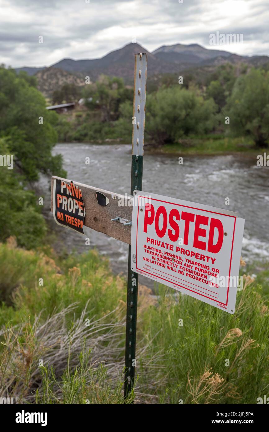 Salida, Colorado - Signs on the banks of the Arkansas River forbid fishing and other activities along or in the river. Private landowners along the Ar Stock Photo