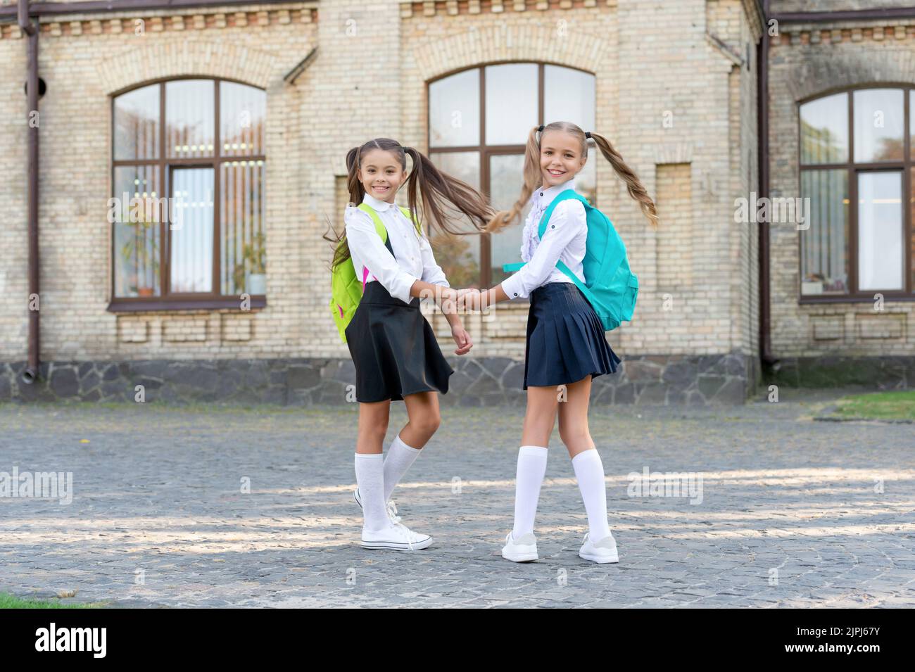 smiling two school girls best friends together outdoor Stock Photo Alamy