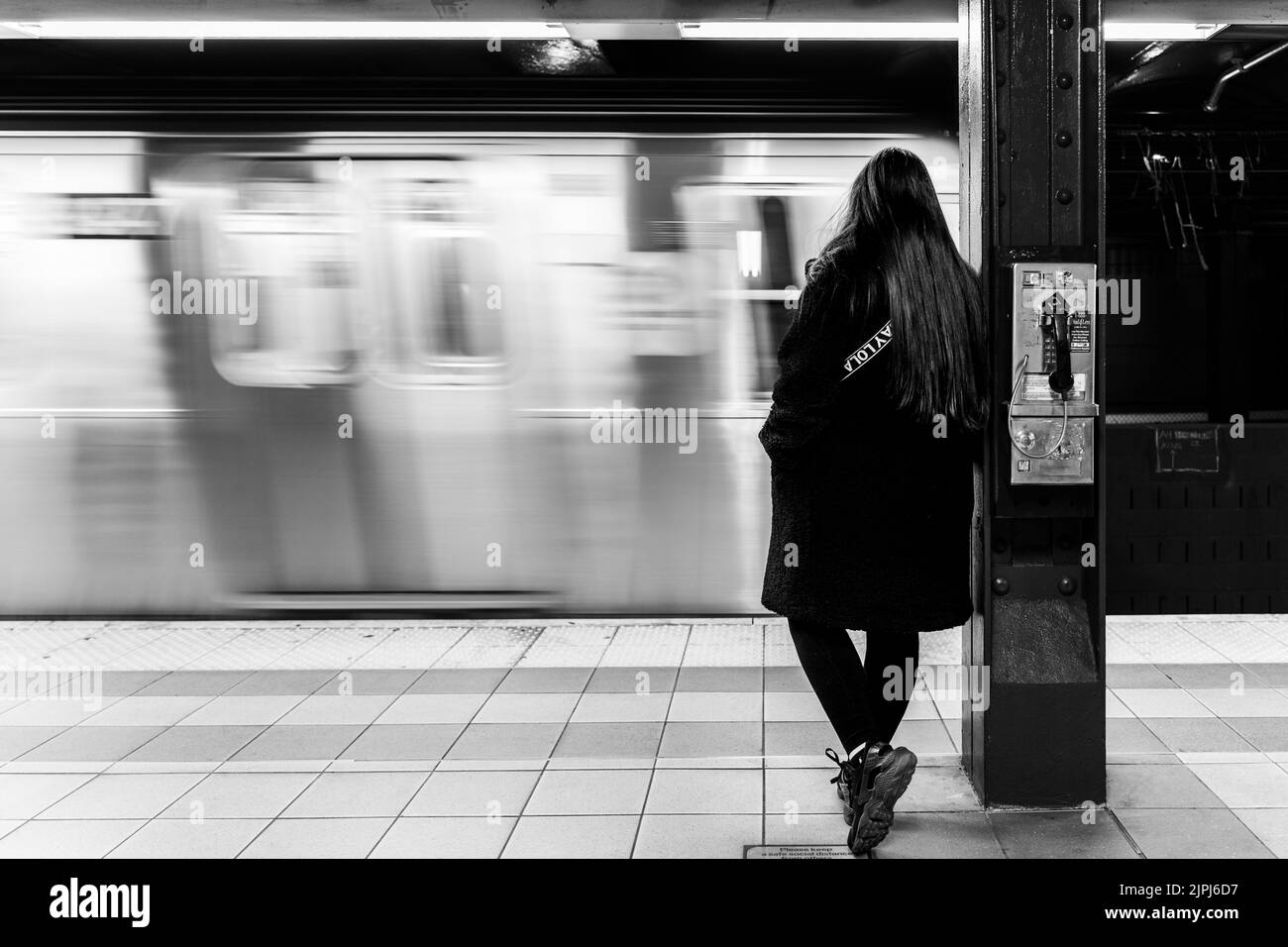 Woman waiting at train station Black and White Stock Photos & Images ...