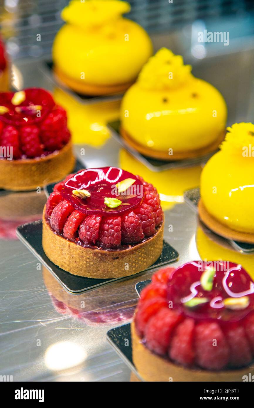Raspberry and pistachio tarts and mango passionfruit cheesecakes at