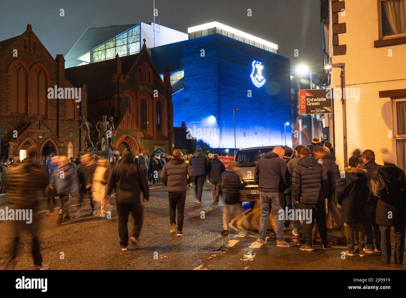 Hungry Everton fans, queuing up for fish and chips at the Goodison Supper Bar, outside Goodison Park before an evening game in March 2022. Stock Photo