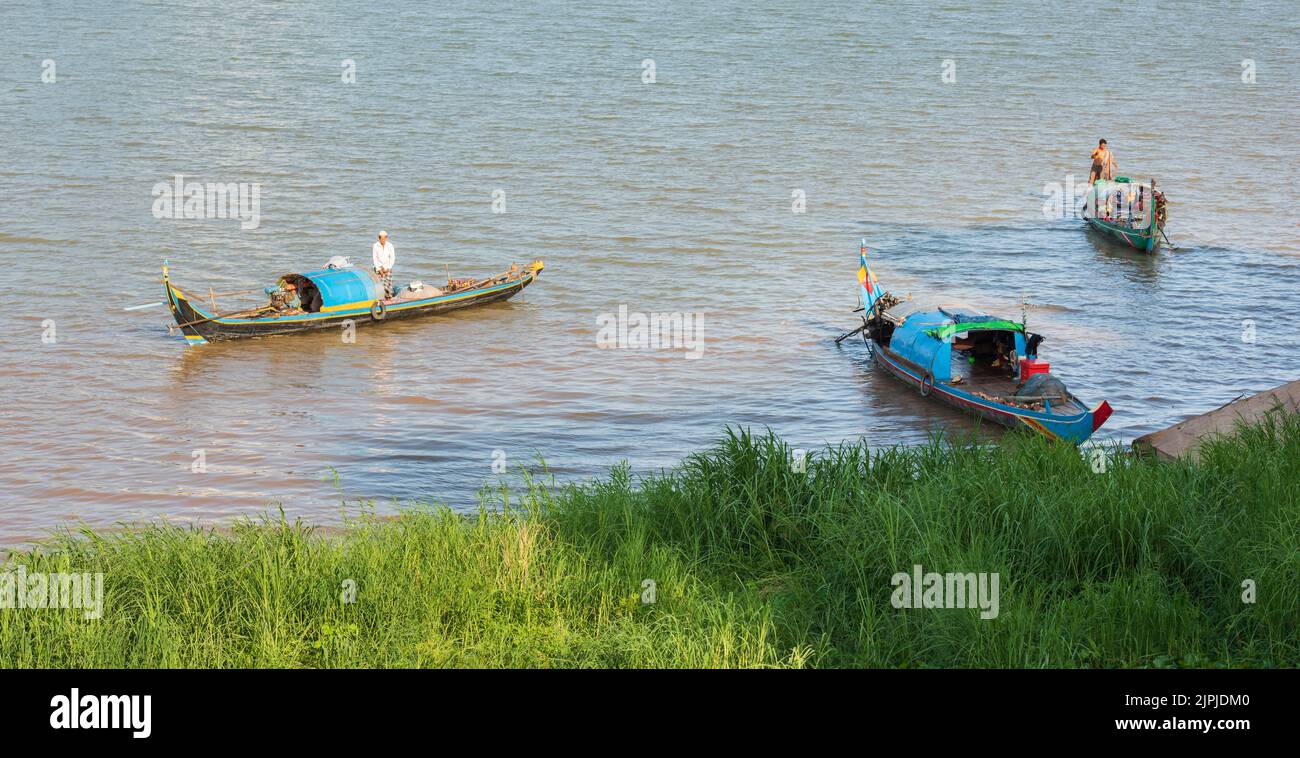 Traditional houseboats on the Mekong river. People who live on the riverboat. The boats are being used both as fishing and as a home Stock Photo