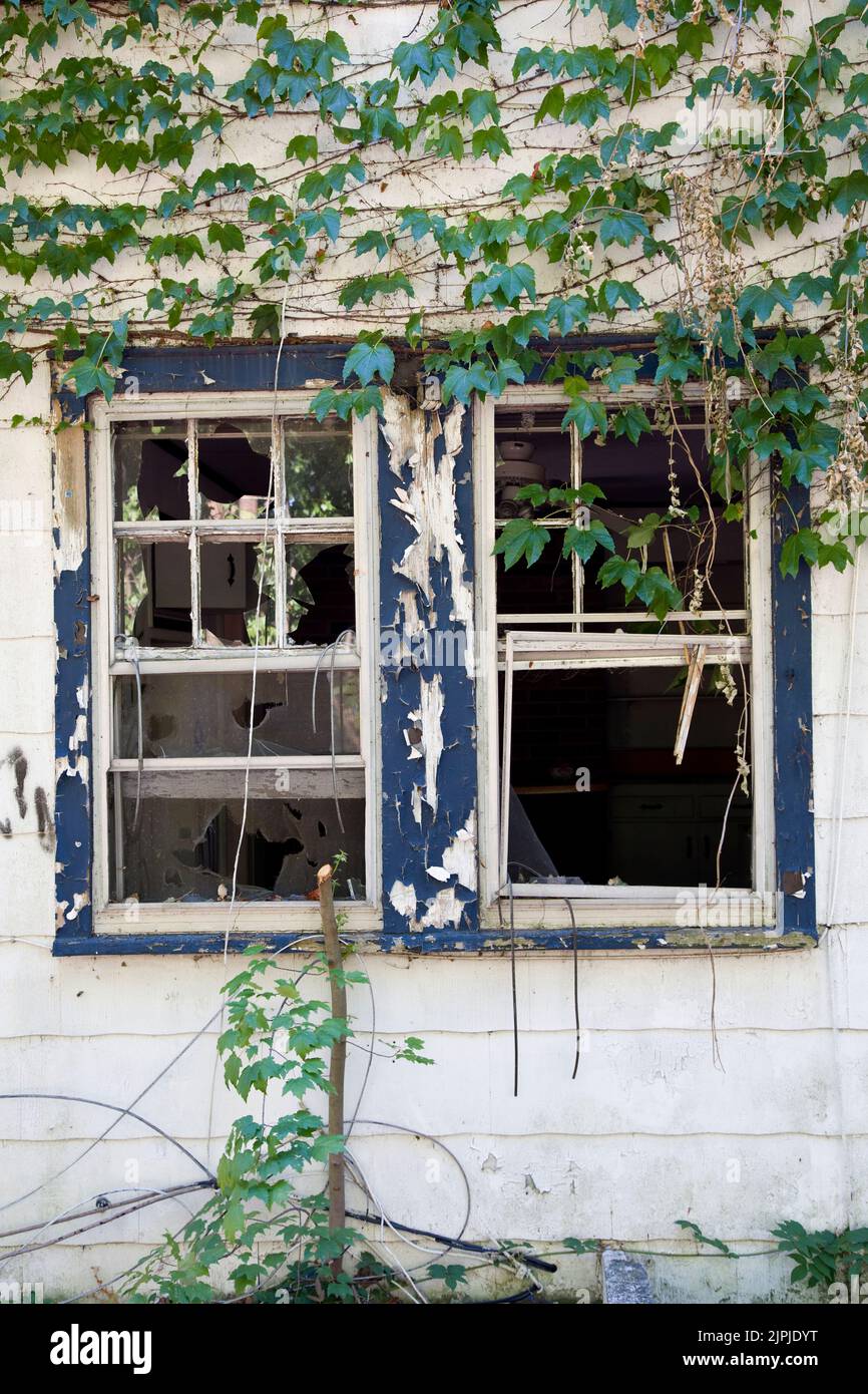 Abandoned house broken windows Stock Photo