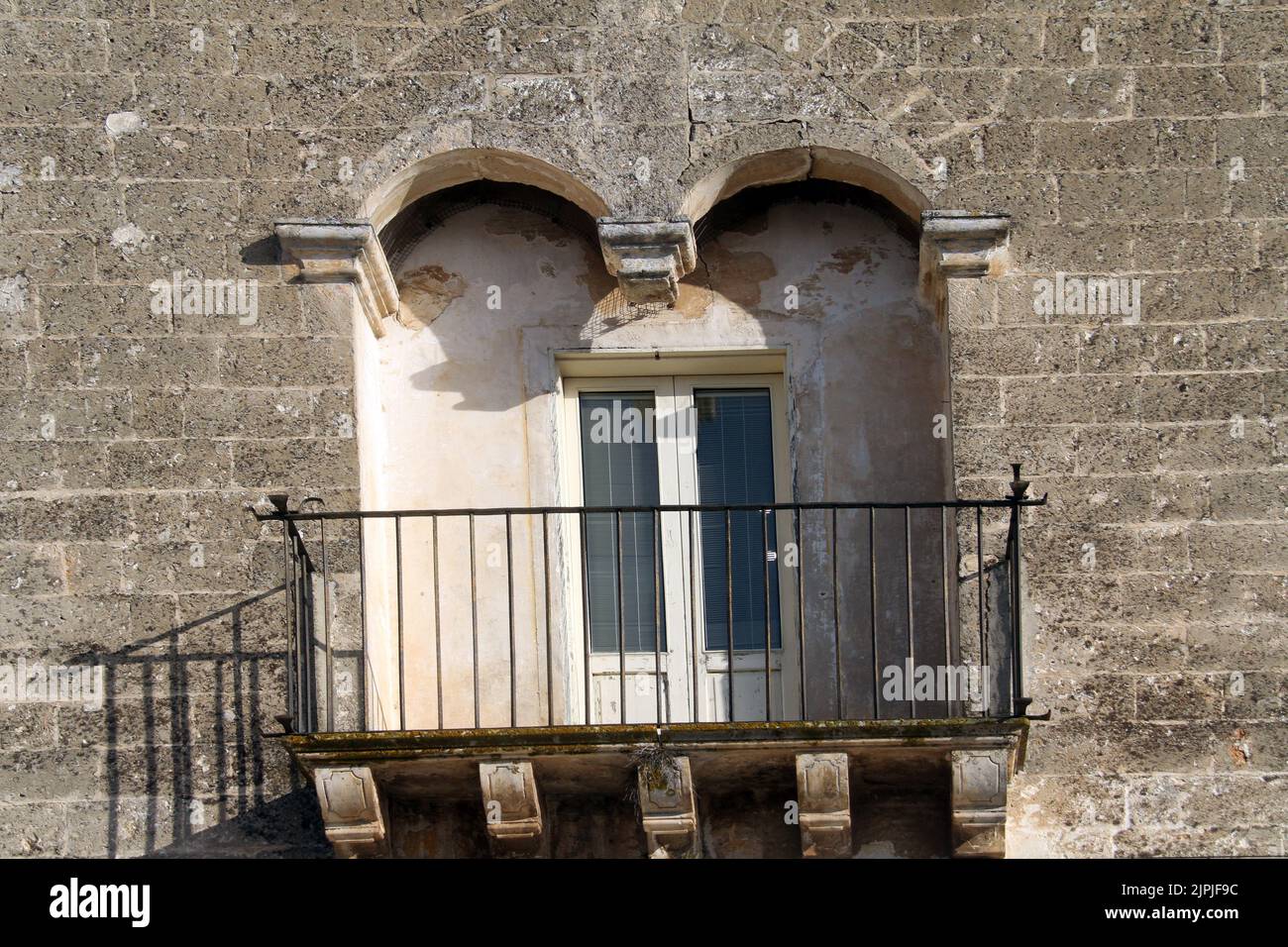 Balcony sustained by corbels on an old building in Carovigno, Italy Stock Photo