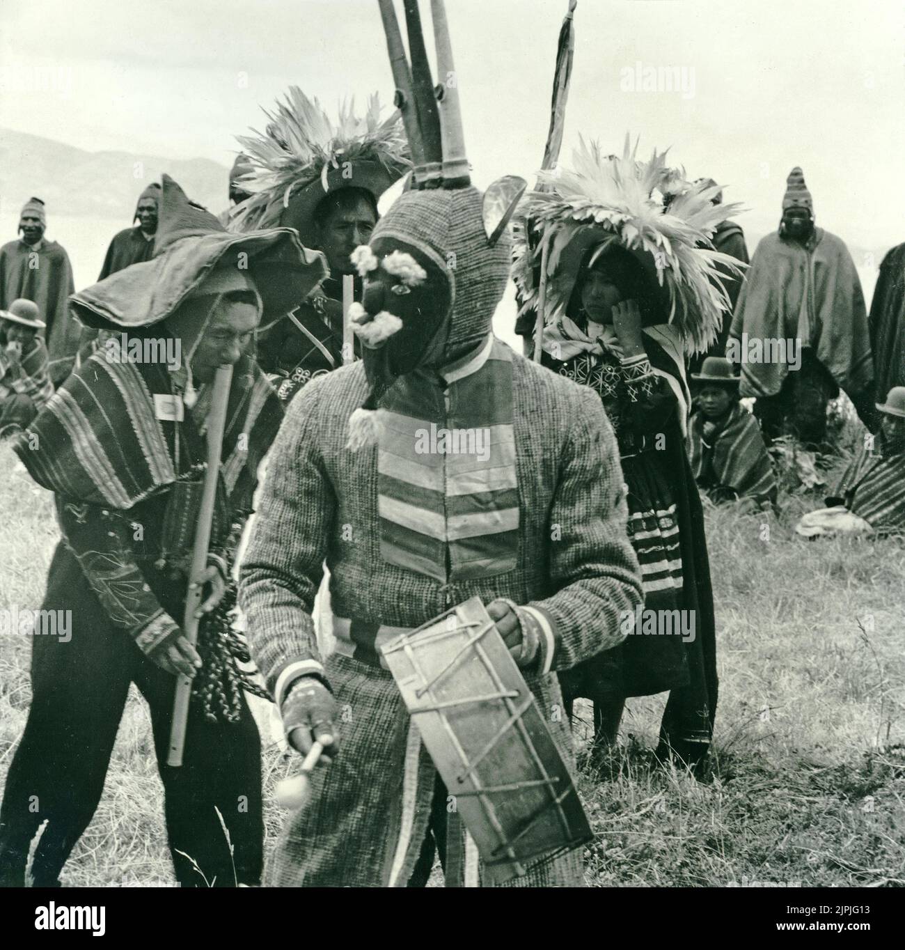 Indigenous people dressed in traditional costumes wearing masks and playing musical instruments including the tarka or tharqa, a long wooden flute of the Andes, Bolivia, South America Stock Photo