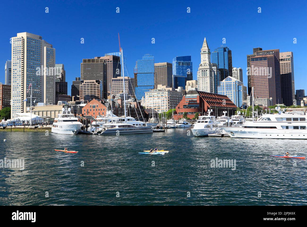 Boston skyline and harbor with boats, kayaks and Atlantic Ocean on the foreground, USA Stock Photo